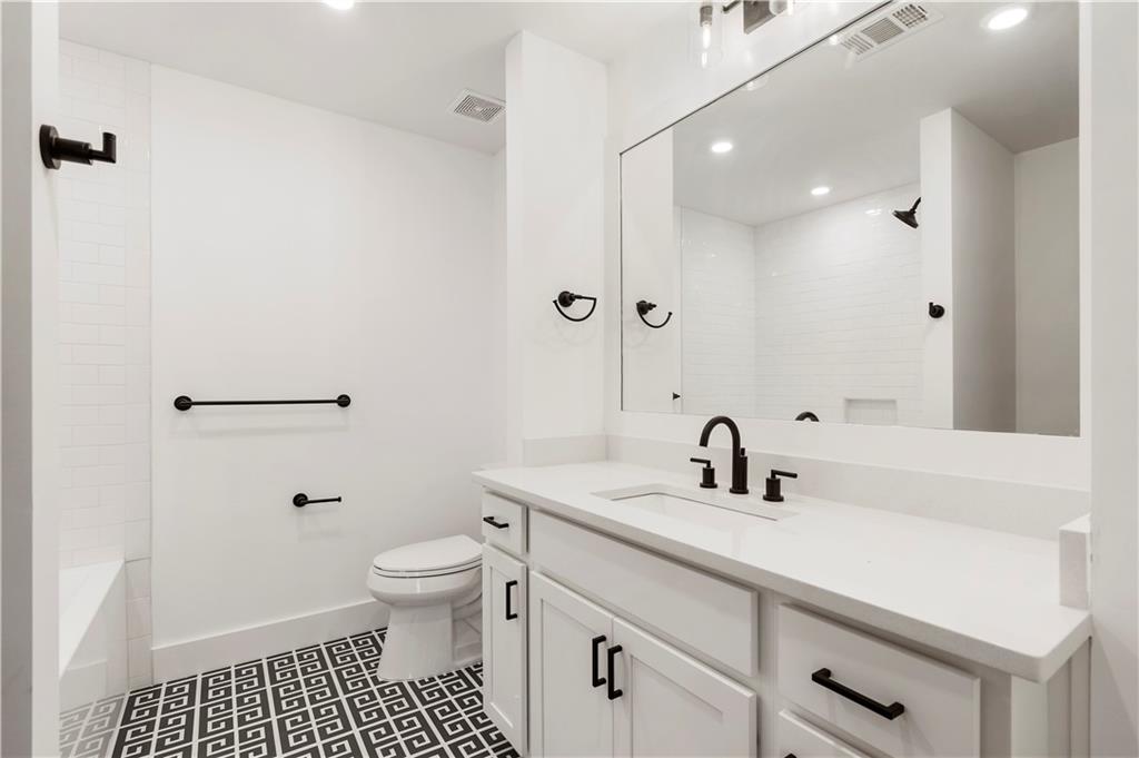 1901 Browns Mill Road Southeast Atlanta, GA 30315 - Photo 31 of 42 a bathroom with a sink a toilet and shower