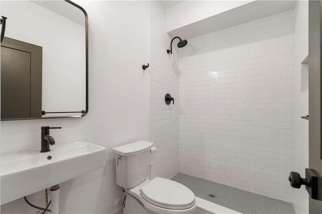 1901 Browns Mill Road Southeast Atlanta, GA 30315 - Photo 38 of 42 a bathroom with a sink a toilet and shower