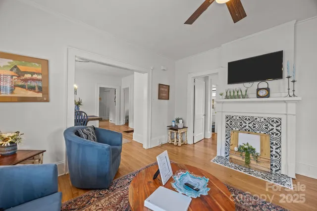 a living room with furniture a flat screen tv and a fireplace
