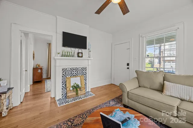 a living room with furniture fireplace and flat screen tv