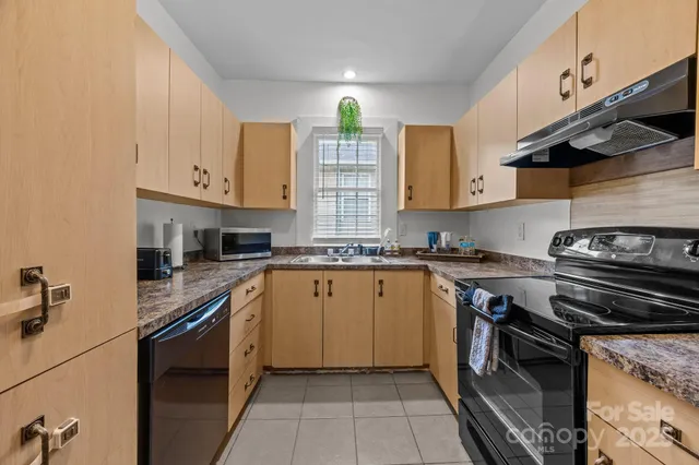 a kitchen with stainless steel appliances granite countertop a stove sink and cabinets