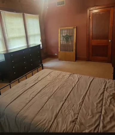 a bedroom with a bed and a dresser