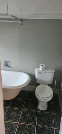 a bathroom with a toilet a sink and a mirror