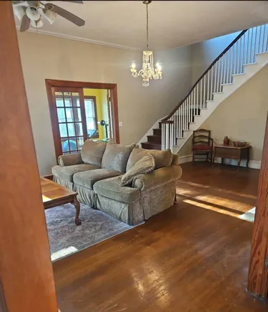 a living room with furniture and a chandelier