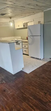 a view of a kitchen with wooden floor