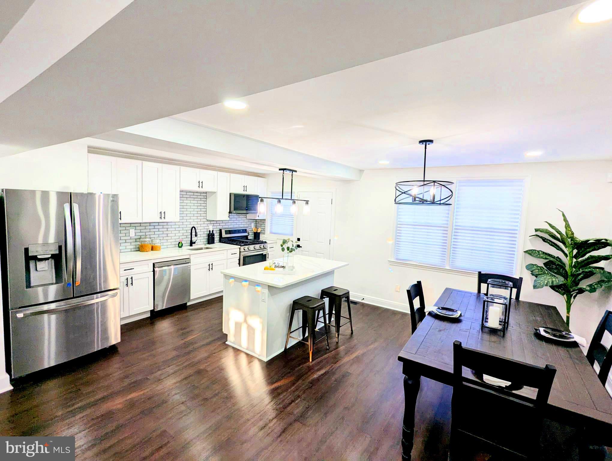 809 Wedgewood Road Baltimore, MD 21229 - Photo 1 of 36 a kitchen with white cabinets and stainless steel appliances