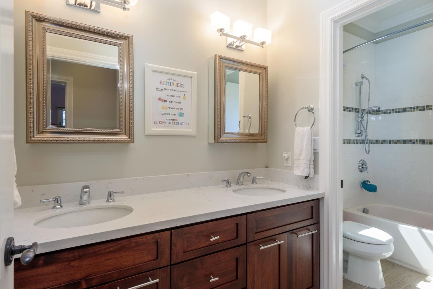 1120 Southdown Road Hillsborough, CA 94010 - Photo 20 of 28 a bathroom with a double vanity sink toilet and a mirror