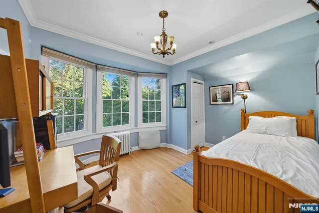 a bedroom with furniture and large windows