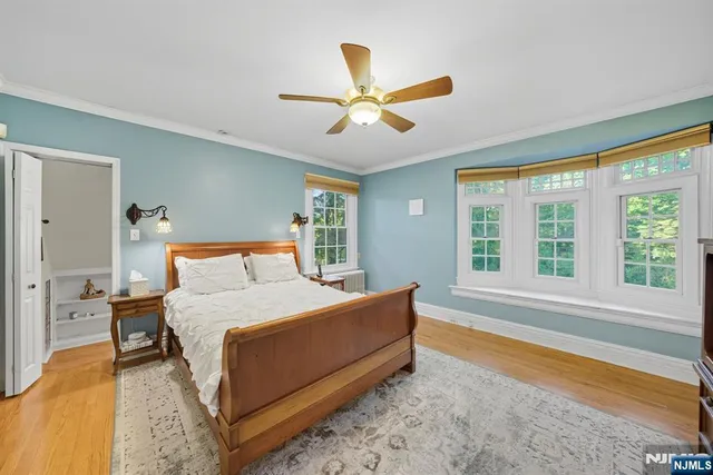 a bedroom with a bed and a large window