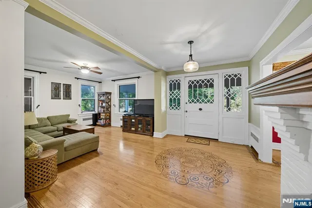 a living room with fireplace furniture and a chandelier