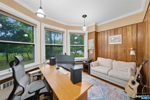 a living room with furniture and large windows