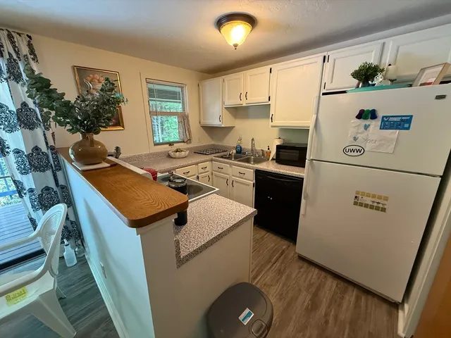 a kitchen with sink a refrigerator and a stove
