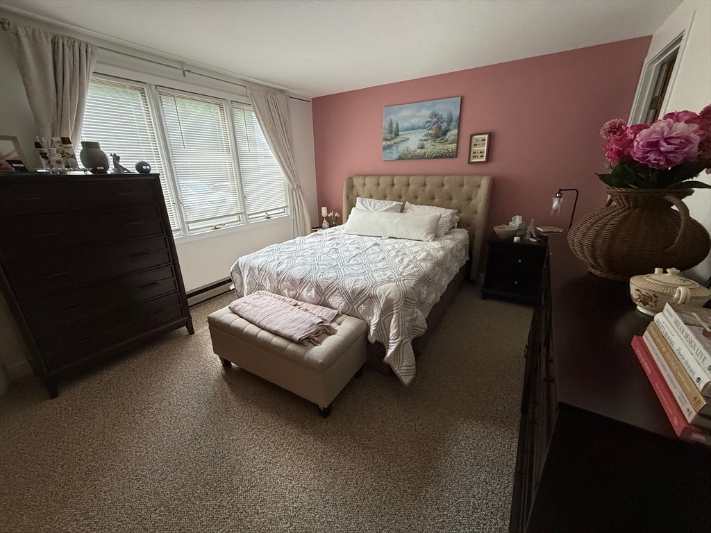 28 Maria Avenue, Unit C Southbridge, MA 01550 - Photo 4 of 11 a bedroom with a bed and wooden floor