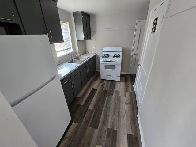 a view of washer and dryer with wooden floor