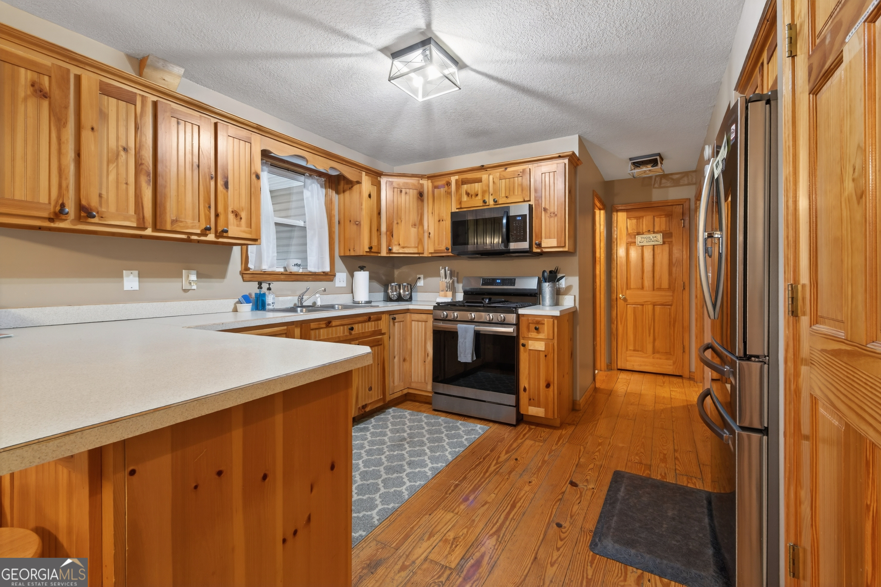 697 Zeppelin Strasse Helen, GA 30545 - Photo 13 of 56 a kitchen with stainless steel appliances granite countertop a stove a sink and a refrigerator