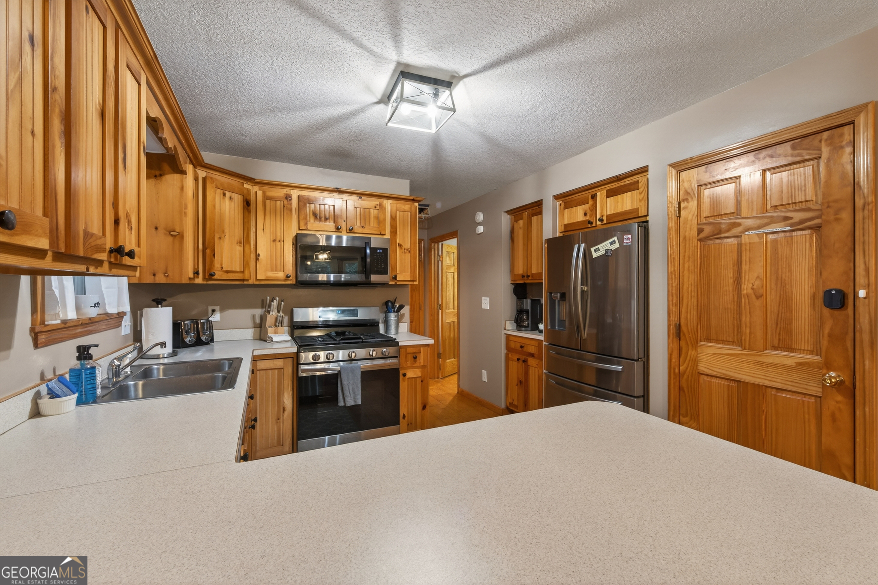 697 Zeppelin Strasse Helen, GA 30545 - Photo 14 of 56 a kitchen with stainless steel appliances granite countertop a refrigerator stove top oven a sink and dishwasher
