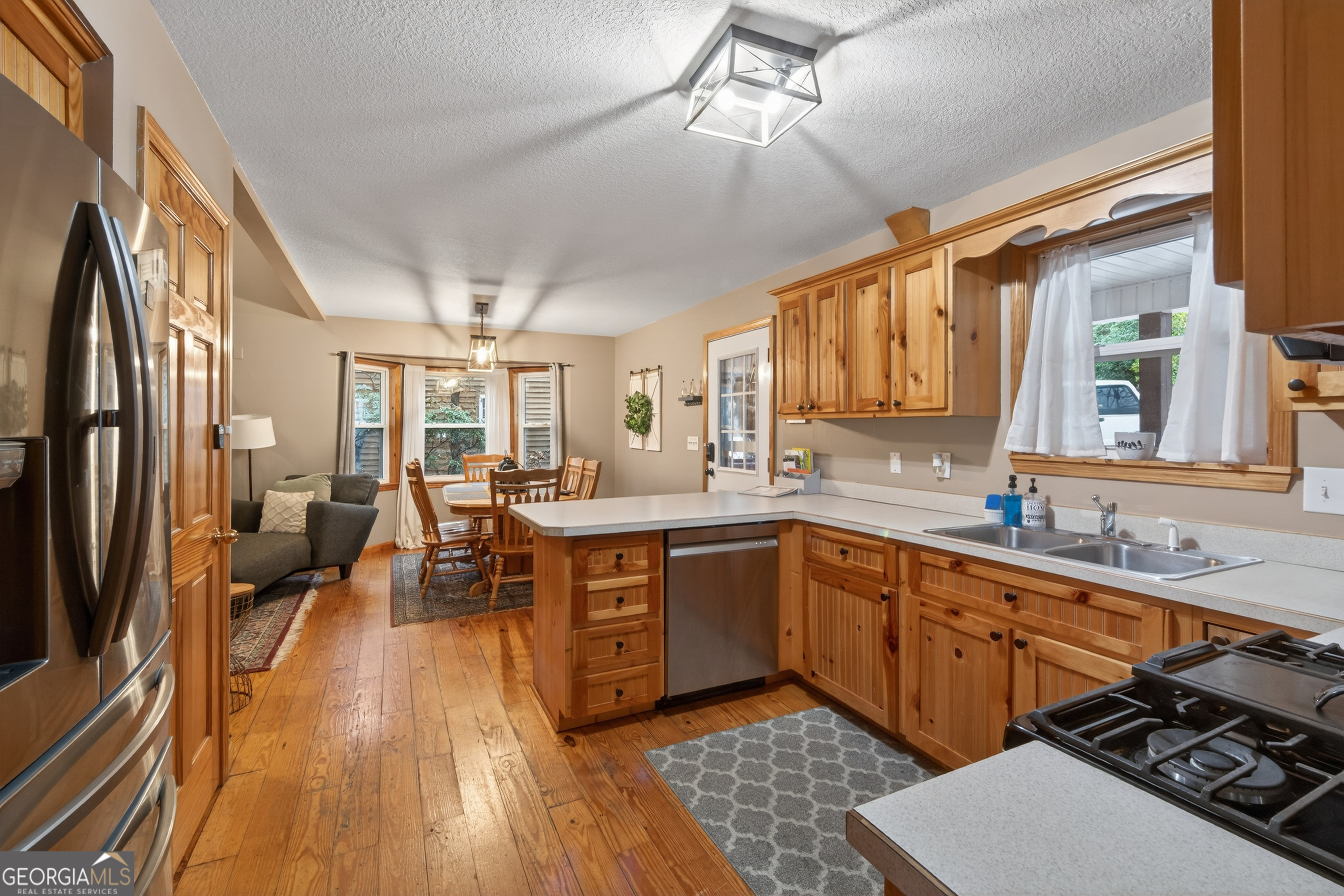 697 Zeppelin Strasse Helen, GA 30545 - Photo 15 of 56 a large kitchen with a large window and stainless steel appliances