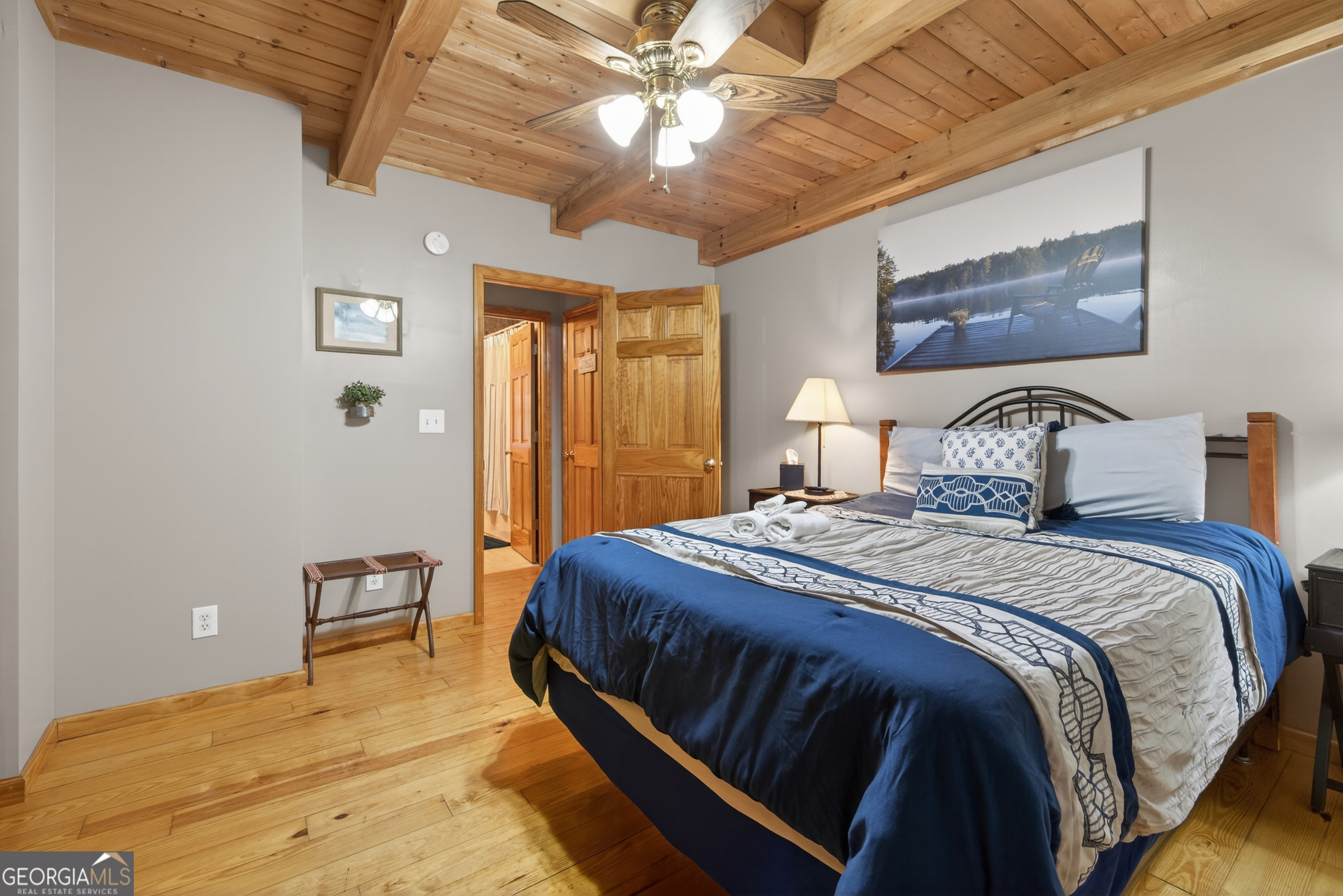 697 Zeppelin Strasse Helen, GA 30545 - Photo 19 of 56 a bedroom with a bed and a chandelier