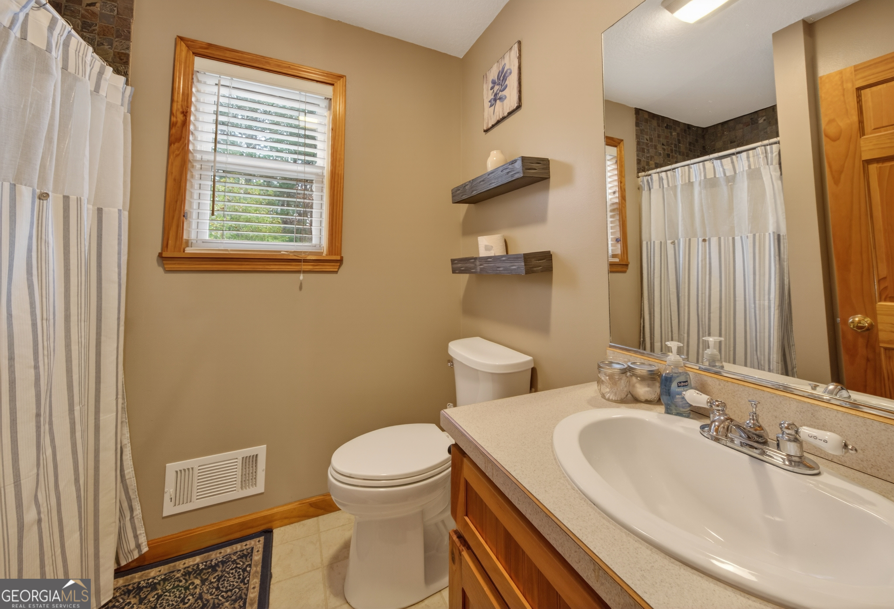 697 Zeppelin Strasse Helen, GA 30545 - Photo 22 of 56 a bathroom with a sink a toilet and a mirror