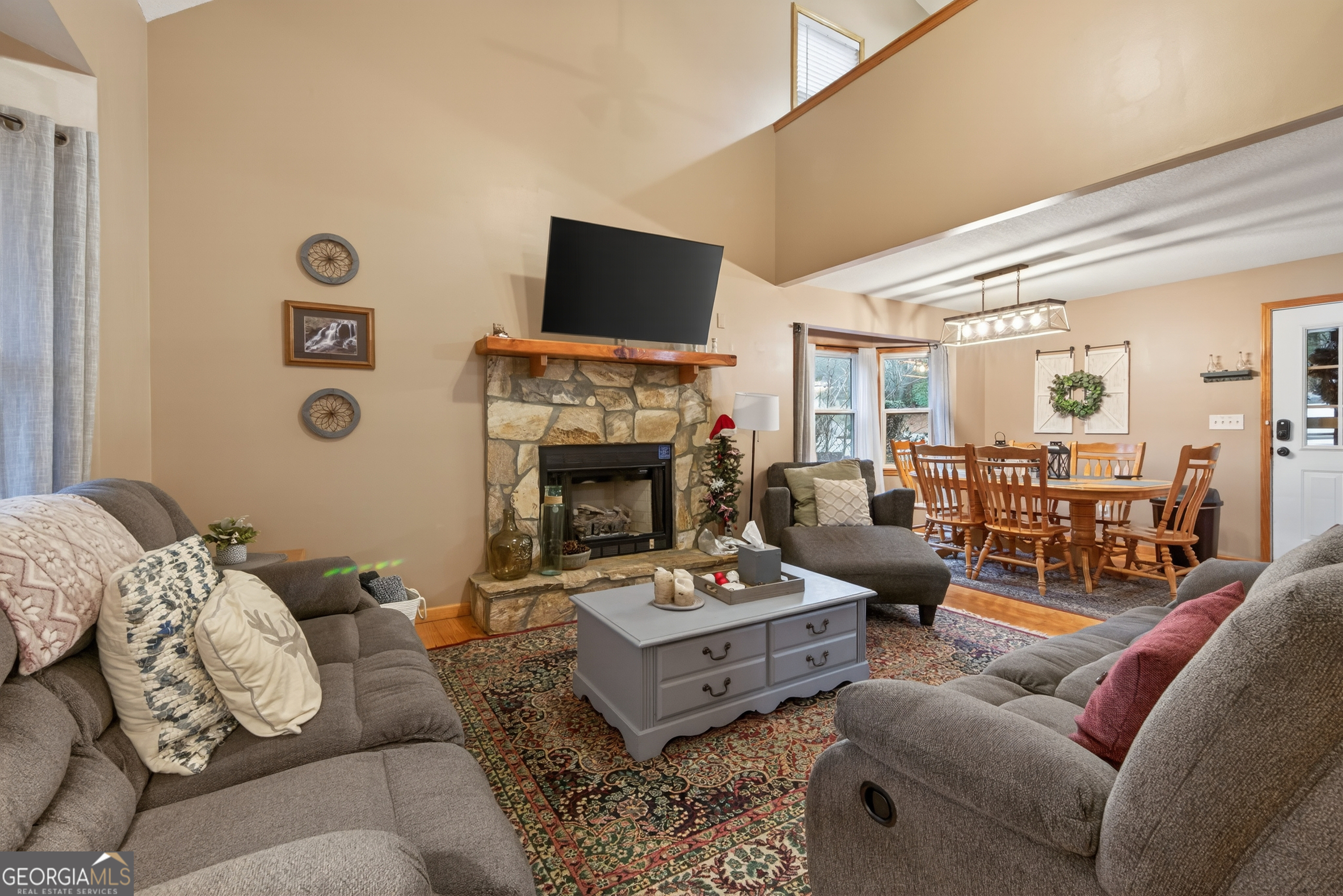 697 Zeppelin Strasse Helen, GA 30545 - Photo 6 of 56 a living room with furniture a fireplace and a flat screen tv