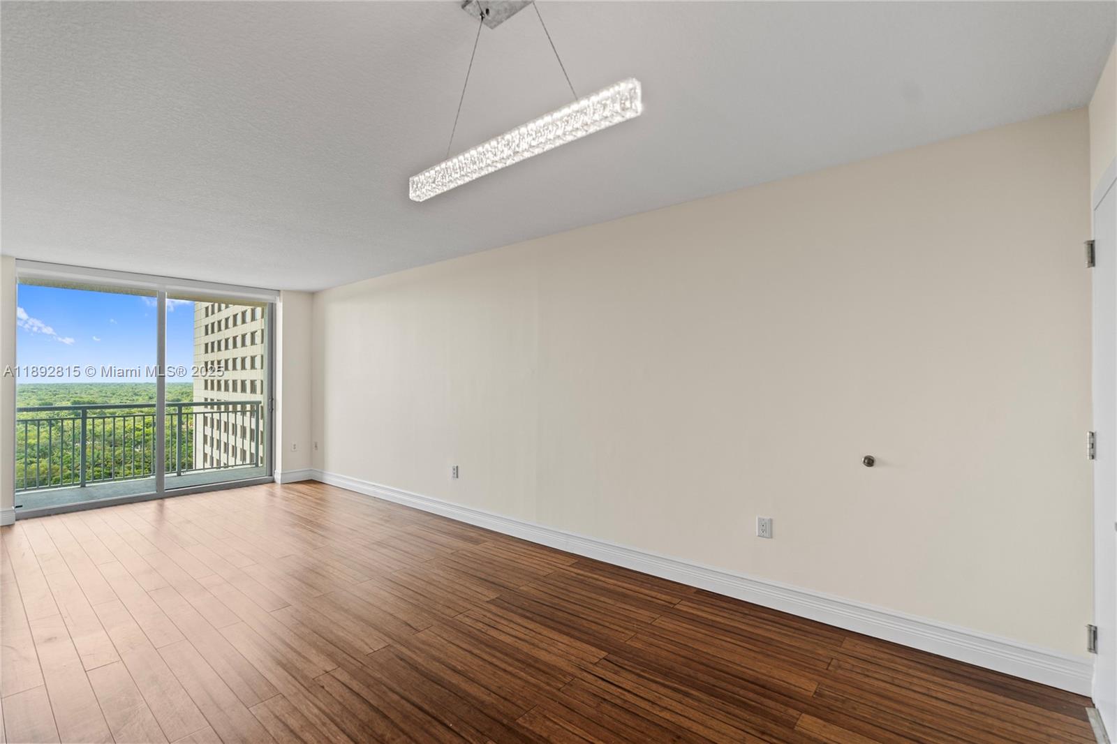 9055 Southwest 73rd Court, Unit 1502 Miami, FL 33156 - Photo 14 of 41 an empty room with wooden floor and windows