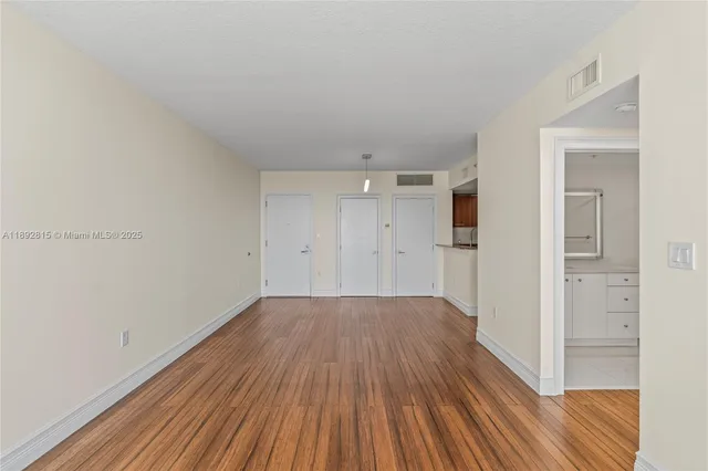 a view of a room with wooden floor