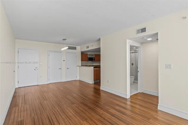 a view of a hardwood floor in an empty room