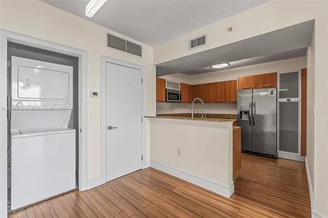 a kitchen with a refrigerator and a sink