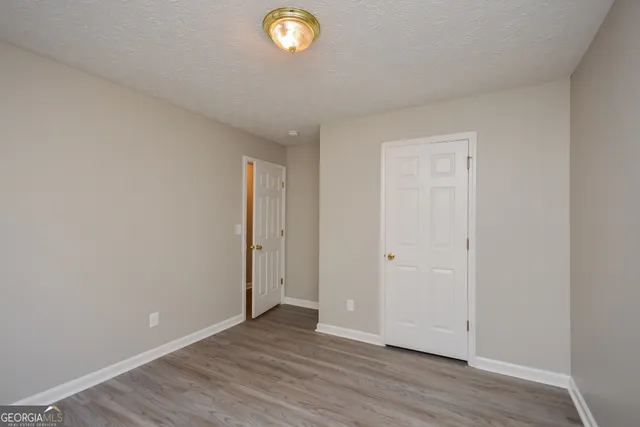 a view of an empty room and wooden floor