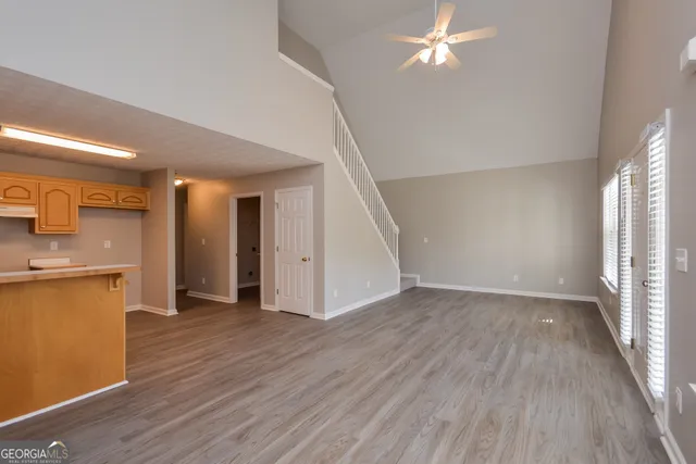 a view of a kitchen with wooden floor and a kitchen space