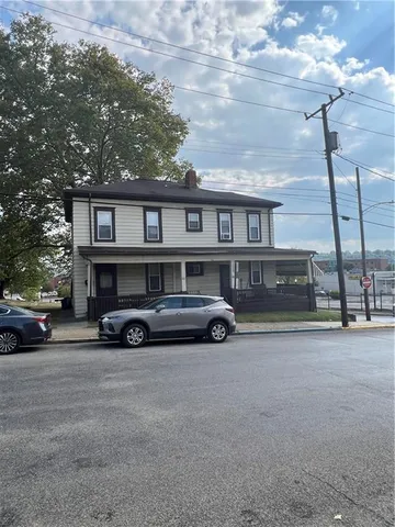 a view of car parked in front of a house