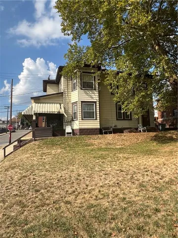 a front view of a house with a yard
