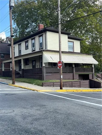 a view of a house with swimming pool and a yard