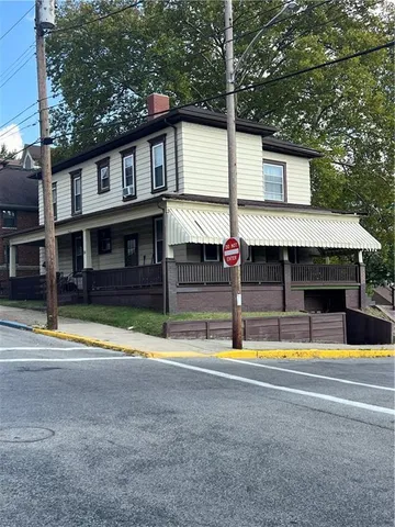 a view of a house with swimming pool and a yard