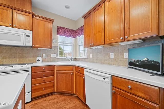 a kitchen with stainless steel appliances granite countertop a sink and cabinets