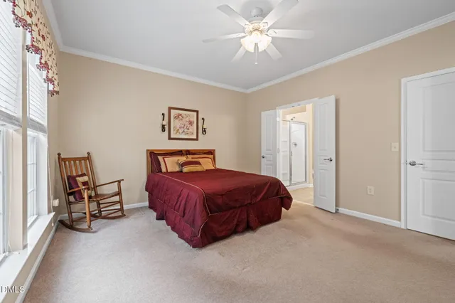 a spacious bedroom with a bed and a window