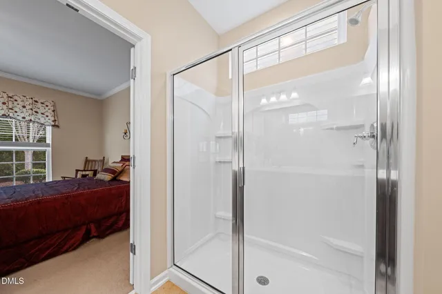 a en suite bathroom with a granite countertop sink and a mirror