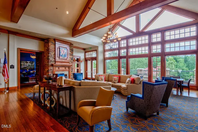 a living room with furniture a wooden floor and a large window