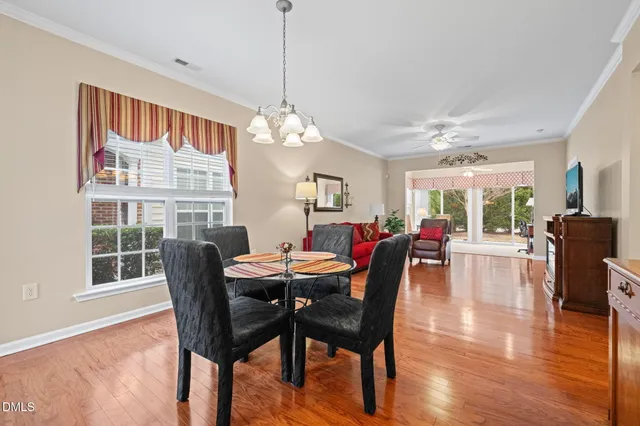 a view of a dining room with furniture window and wooden floor