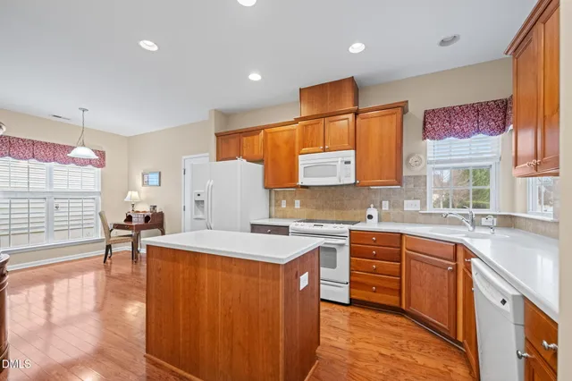 a kitchen with a sink appliances and cabinets