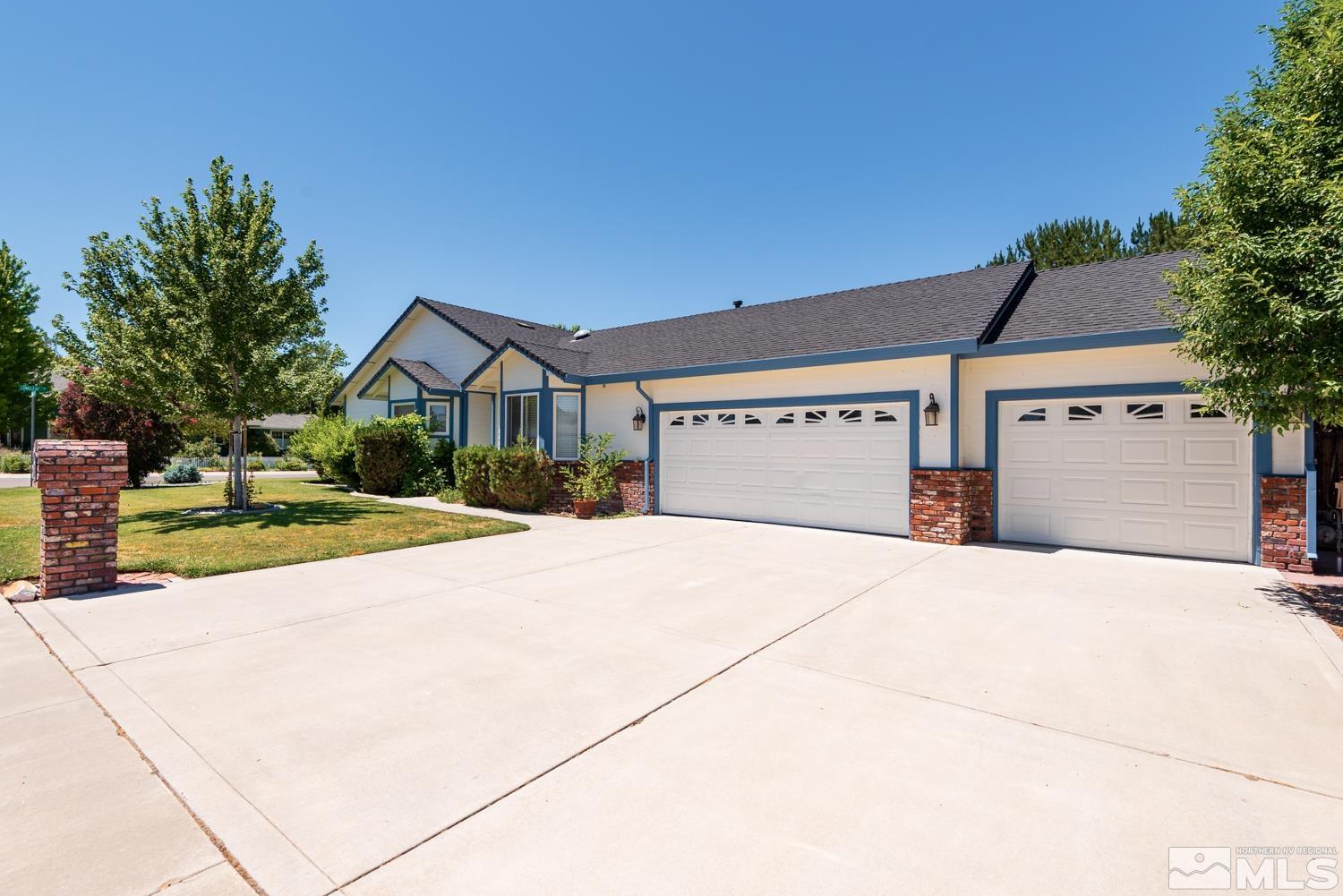 877 Longleaf Place Minden, NV 89423 - Photo 1 of 39 a front view of a house with a yard and garage