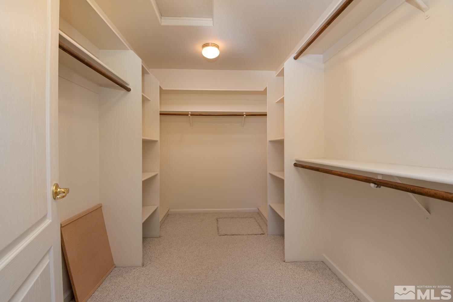 877 Longleaf Place Minden, NV 89423 - Photo 24 of 39 a view of walk in closet with empty racks