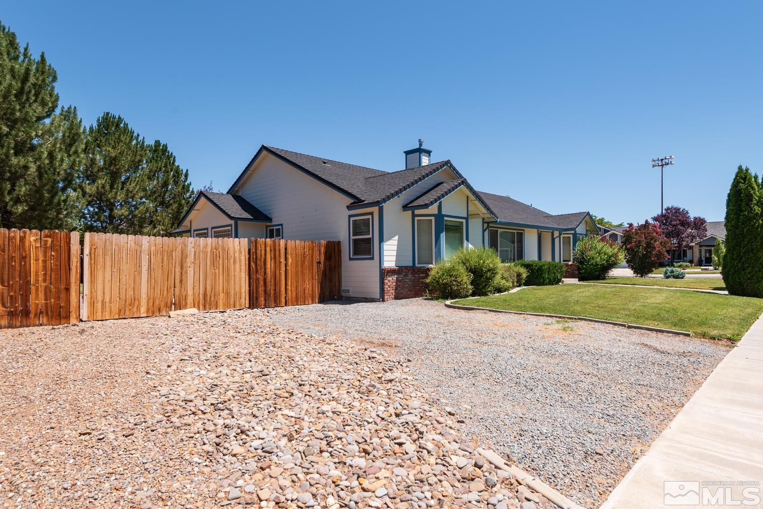 877 Longleaf Place Minden, NV 89423 - Photo 25 of 39 a front view of a house with a yard and garage