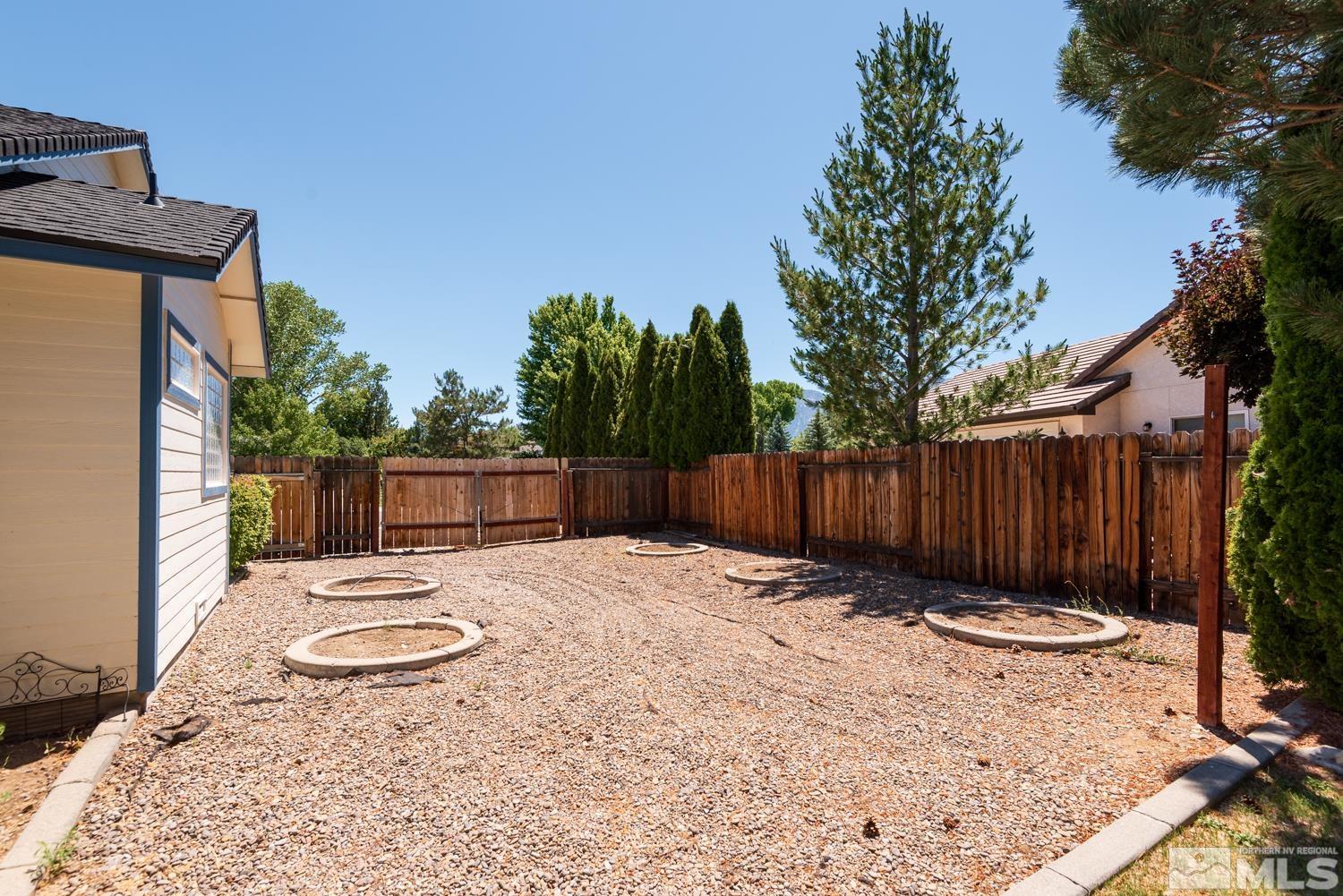 877 Longleaf Place Minden, NV 89423 - Photo 27 of 39 a backyard of a house with table and chairs