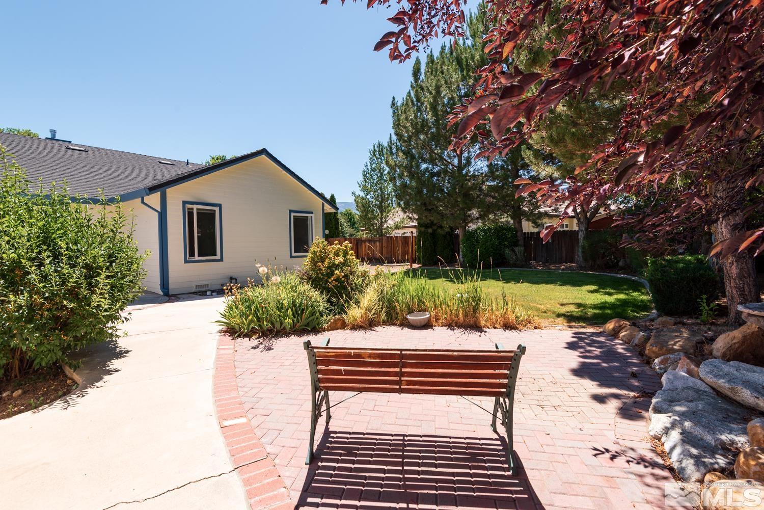 877 Longleaf Place Minden, NV 89423 - Photo 38 of 39 a view of a chairs and tables in the backyard