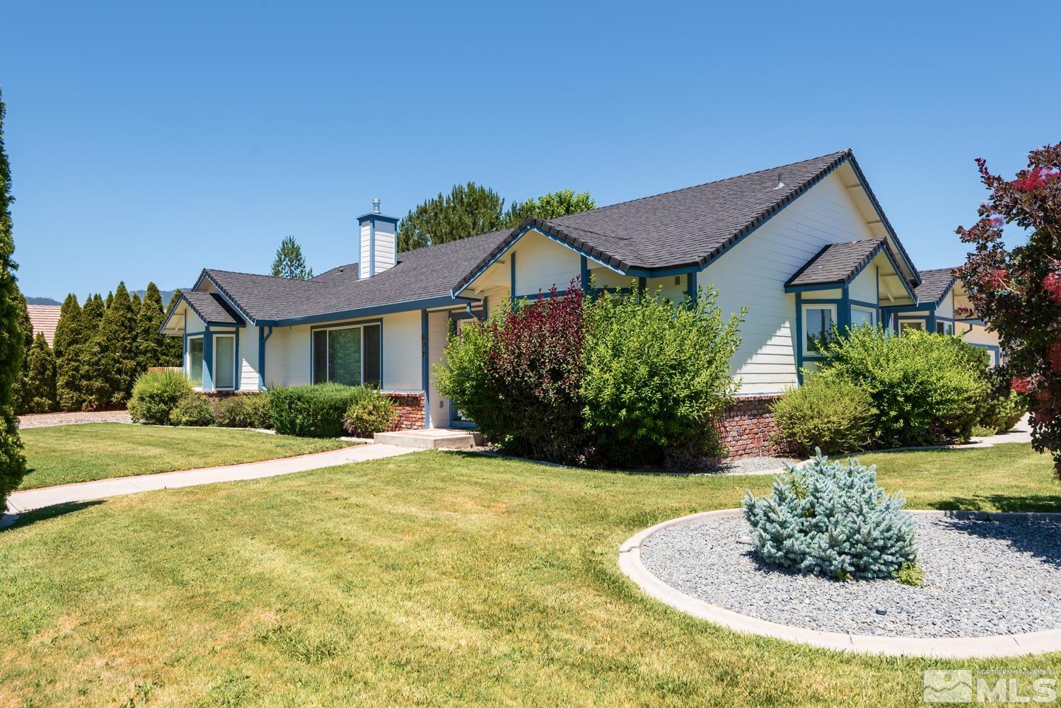 877 Longleaf Place Minden, NV 89423 - Photo 4 of 39 a front view of a house with a yard