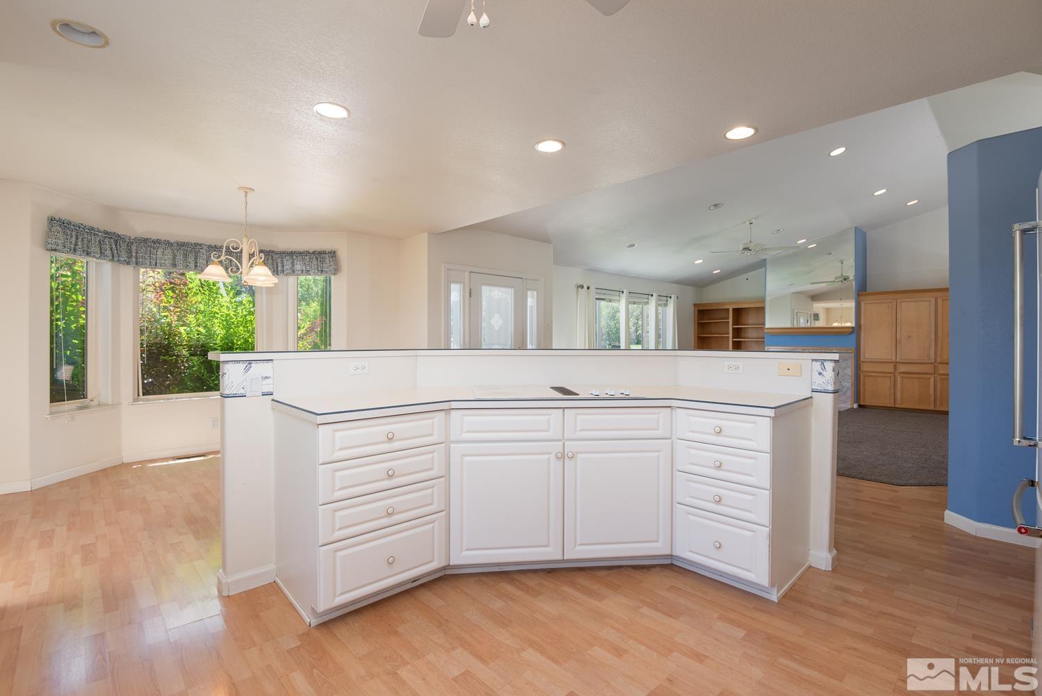 877 Longleaf Place Minden, NV 89423 - Photo 5 of 39 a large white kitchen with a large window appliances and cabinets