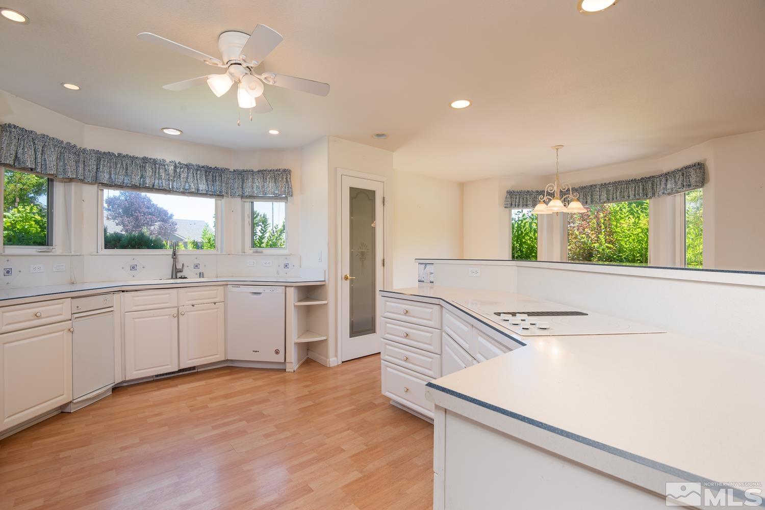 877 Longleaf Place Minden, NV 89423 - Photo 6 of 39 a kitchen with a stove a sink and a refrigerator