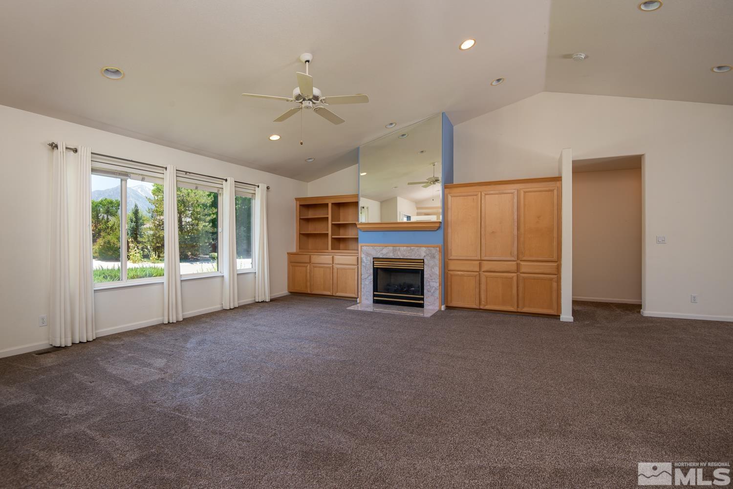 877 Longleaf Place Minden, NV 89423 - Photo 9 of 39 a view of a livingroom with an empty space and a fireplace