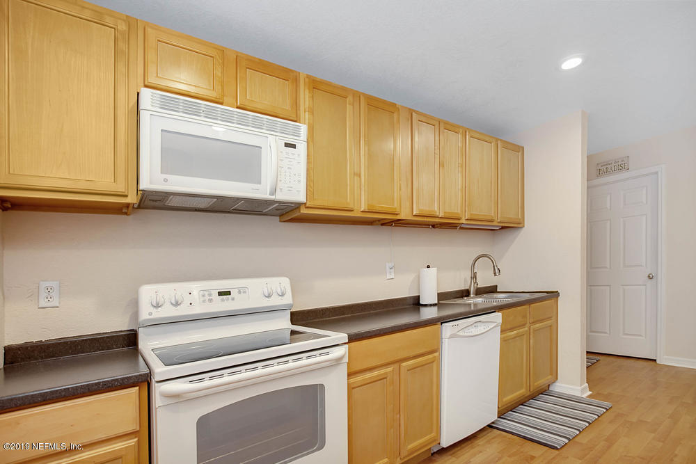 760 Triton Road Atlantic Beach, FL 32233 - Photo 13 of 24 a kitchen with sink cabinets and appliances